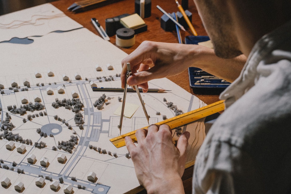 Architectural blueprints and professional drafting tools on a desk.