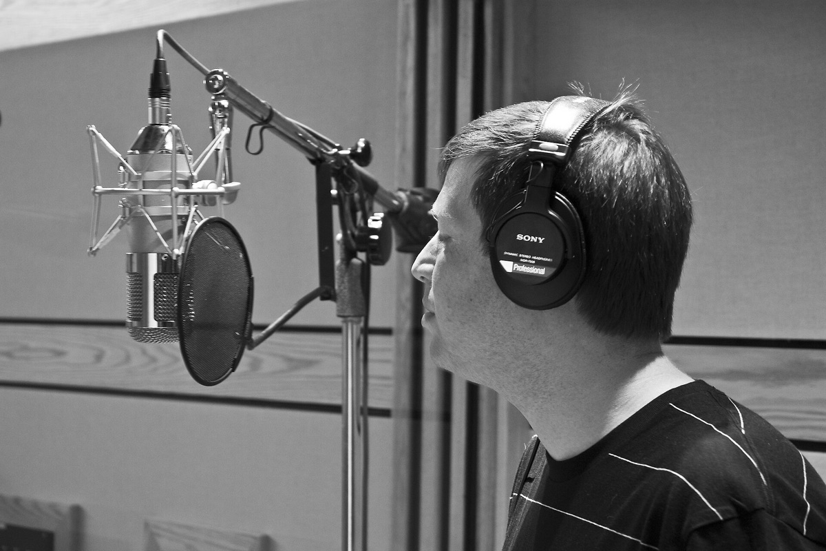 Professional studio microphone and headphones for content creation.